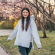 Happy teenage girl walking in spring park with blooming trees Happy teenage girl walking in spring park with blooming trees - PhotoDune Item for Sale