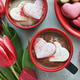 Valentine's Day hot cocoa with heart-shaped marshmallows, chocolates, tulips Valentine's Day hot cocoa with heart-shaped marshmallows, chocolates, tulips - PhotoDune Item for Sale