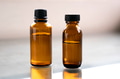 Two Amber glass bottles on natural background Two Amber glass bottles on natural background - PhotoDune Item for Sale