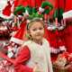 Children choose a santa claus hat in the shop Children choose a santa claus hat in the shop - PhotoDune Item for Sale