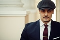 Portrait of retro 1920s english arabian business man wearing dark suit, tie and flat cap. Portrait of retro 1920s english arabian business man wearing dark suit, tie and flat cap. - PhotoDune Item for Sale