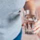 World Water Day. Woman holds glass of clean water in her hands. World Water Day. Woman holds glass of clean water in her hands. - PhotoDune Item for Sale