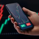 trader using a mobile trading platform application on smartphone trader using a mobile trading platform application on smartphone - PhotoDune Item for Sale