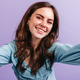 Green-eyed girl in high spirits looks into camera. Selfie of young brunette with snow-white smile a Green-eyed girl in high spirits looks into camera. Selfie of young brunette with snow-white smile a - PhotoDune Item for Sale