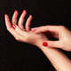Woman hands with beautiful red manicure touching skin on wrist Woman hands with beautiful red manicure touching skin on wrist - PhotoDune Item for Sale