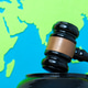 Black judge's gavel against a vibrant green and blue paper world map. Black judge's gavel against a vibrant green and blue paper world map. - PhotoDune Item for Sale