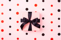 Pink Gift Box with Black Bow on Pink Background with Confetti. Pink Gift Box with Black Bow on Pink Background with Confetti. - PhotoDune Item for Sale