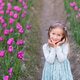 Adorable little caucasian blonde girl smiling in tulip field at spring day. Adorable little caucasian blonde girl smiling in tulip field at spring day. - PhotoDune Item for Sale