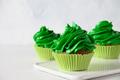 Homemade chocolate cupcake with with green whipped cream. Homemade chocolate cupcake with with green whipped cream. - PhotoDune Item for Sale