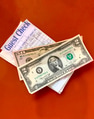 Overhead view of check with money on top of it on a red background at the cafe. Overhead view of check with money on top of it on a red background at the cafe. - PhotoDune Item for Sale