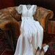 Elegant white wedding dress on a vintage leather armchair with shoes Elegant white wedding dress on a vintage leather armchair with shoes - PhotoDune Item for Sale