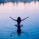 Woman sitting cross-legged on water with ripples in serene setting. WA, USA Woman sitting cross-legged on water with ripples in serene setting. WA, USA - PhotoDune Item for Sale