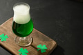Patrick's day green beer and shamrock symbol on black table. Patrick's day green beer and shamrock symbol on black table. - PhotoDune Item for Sale