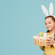 Cheerful girl with basket of Easter eggs Cheerful girl with basket of Easter eggs - PhotoDune Item for Sale