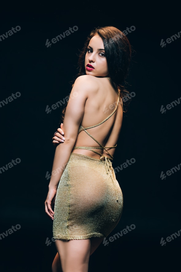 elegant young woman in golden transparent dress with sexy buttocks isolated on black Stock Photo by LightFieldStudios elegant young woman in golden transparent dress with sexy buttocks isolated on black Stock Photo by LightFieldStudios
