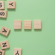 Three wooden blocks are on a green background with the letters Three wooden blocks are on a green background with the letters - PhotoDune Item for Sale