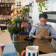 Florist owner checking his phone while sitting in his shop surrounded by flowers Florist owner checking his phone while sitting in his shop surrounded by flowers - PhotoDune Item for Sale