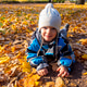Child boy in autumn park with foliage. He lies on the yellow leaves. Child boy in autumn park with foliage. He lies on the yellow leaves. - PhotoDune Item for Sale