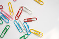 Colored paper clips close-up on a white background Colored paper clips close-up on a white background - PhotoDune Item for Sale