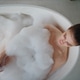 Girl lying foam bath at bathroom morning routine top view. Woman relaxing Girl lying foam bath at bathroom morning routine top view. Woman relaxing - PhotoDune Item for Sale