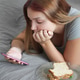 Young Woman Lying on Bed Using Smartphone And Eating Sandwich at Home Young Woman Lying on Bed Using Smartphone And Eating Sandwich at Home - PhotoDune Item for Sale