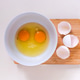 Bright yellow egg yolks in a white bowl. Bright yellow egg yolks in a white bowl. - PhotoDune Item for Sale