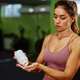 Sportswoman taking supplements after training in gym Sportswoman taking supplements after training in gym - PhotoDune Item for Sale