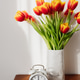 Alarm clock and tulips marking morning time Alarm clock and tulips marking morning time - PhotoDune Item for Sale