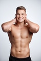 Studio portrait of a muscular young man posing against a grey background Studio portrait of a muscular young man posing against a grey background - PhotoDune Item for Sale