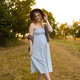 Pregnant woman walking outdoors in summer dress at sunset Pregnant woman walking outdoors in summer dress at sunset - PhotoDune Item for Sale