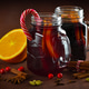 Two glasses with hot mulled wine with orange and spices on a wooden table Two glasses with hot mulled wine with orange and spices on a wooden table - PhotoDune Item for Sale