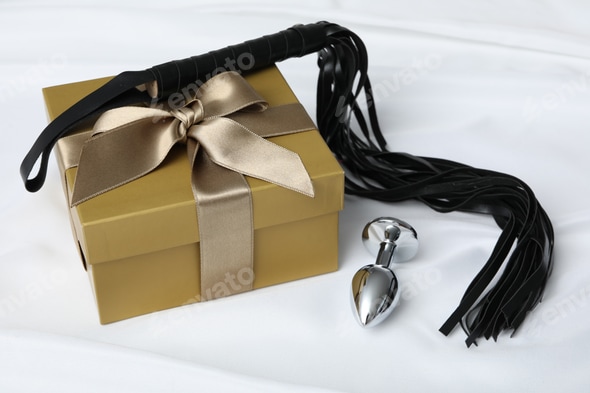 Sex toys as a gift, flogger and anal plug Stock Photo by AtlasComposer Sex toys as a gift, flogger and anal plug Stock Photo by AtlasComposer