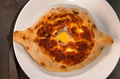 Ajarian khachapuri Georgian cheese pie with egg close Ajarian khachapuri Georgian cheese pie with egg close - PhotoDune Item for Sale
