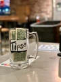 Tips glass jar at business next to cashier with money people leave as tips for workers. Tips glass jar at business next to cashier with money people leave as tips for workers. - PhotoDune Item for Sale
