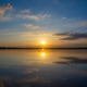 Serene sunset over calm lake with clouds reflecting on water surface. Serene sunset over calm lake with clouds reflecting on water surface. - PhotoDune Item for Sale