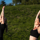 Women practicing yoga outdoors under a clear blue sky at golden hour Women practicing yoga outdoors under a clear blue sky at golden hour - PhotoDune Item for Sale