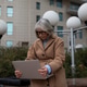 Older woman works on her laptop outdoors in an urban setting surrounded by modern buildings and Older woman works on her laptop outdoors in an urban setting surrounded by modern buildings and - PhotoDune Item for Sale