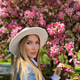 A beautiful young woman a hat near a cherry blossom tree A beautiful young woman a hat near a cherry blossom tree - PhotoDune Item for Sale