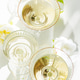 Champagne Glasses with White Peonies. Birthday or Wedding Celebration Arrangement. Top view. Champagne Glasses with White Peonies. Birthday or Wedding Celebration Arrangement. Top view. - PhotoDune Item for Sale