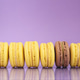 Row of colorful macarons on the purple background. Row of colorful macarons on the purple background. - PhotoDune Item for Sale