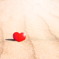 Romantic symbol of red heart on the sand beach Romantic symbol of red heart on the sand beach - PhotoDune Item for Sale