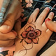 A hand with intricate henna designs, swirling patterns in reddish-brown, captivating work of art A hand with intricate henna designs, swirling patterns in reddish-brown, captivating work of art - PhotoDune Item for Sale