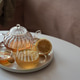 Glass teapot with amber tea, teacup with lemon slice, and bowl of honey Glass teapot with amber tea, teacup with lemon slice, and bowl of honey - PhotoDune Item for Sale