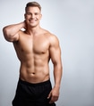 Studio portrait of a muscular young man posing against a grey background Studio portrait of a muscular young man posing against a grey background - PhotoDune Item for Sale