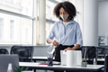 Disinfection from coronavirus in coworking place. African american young woman in protective mask Disinfection from coronavirus in coworking place. African american young woman in protective mask - PhotoDune Item for Sale