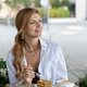 Stylish Woman Enjoying Cake and Coffee at Outdoor Cafe Table in a Modern Urban Setting with Greenery Stylish Woman Enjoying Cake and Coffee at Outdoor Cafe Table in a Modern Urban Setting with Greenery - PhotoDune Item for Sale