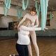 Trainer helping pregnant woman to do excercises with a yoga hammock Trainer helping pregnant woman to do excercises with a yoga hammock - PhotoDune Item for Sale