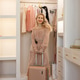 Portrait of middle aged blonde woman posing with luggage or suitcase in fitting room at home. Portrait of middle aged blonde woman posing with luggage or suitcase in fitting room at home. - PhotoDune Item for Sale