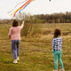 Children girls running flying colorful sky kite. Open field. Spring day. Family nature activity, fun Children girls running flying colorful sky kite. Open field. Spring day. Family nature activity, fun - PhotoDune Item for Sale