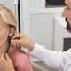 Audiologist carefully adjusts a hearing aid on a woman using advanced audiological equipment Audiologist carefully adjusts a hearing aid on a woman using advanced audiological equipment - PhotoDune Item for Sale